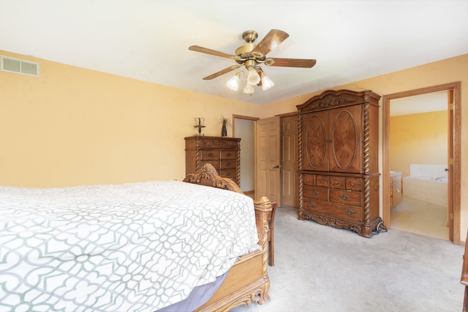 2104 Olde Mill Road Plainfield, IL 60586 - Photo 13 of 23 a bedroom with a bed and a chandelier