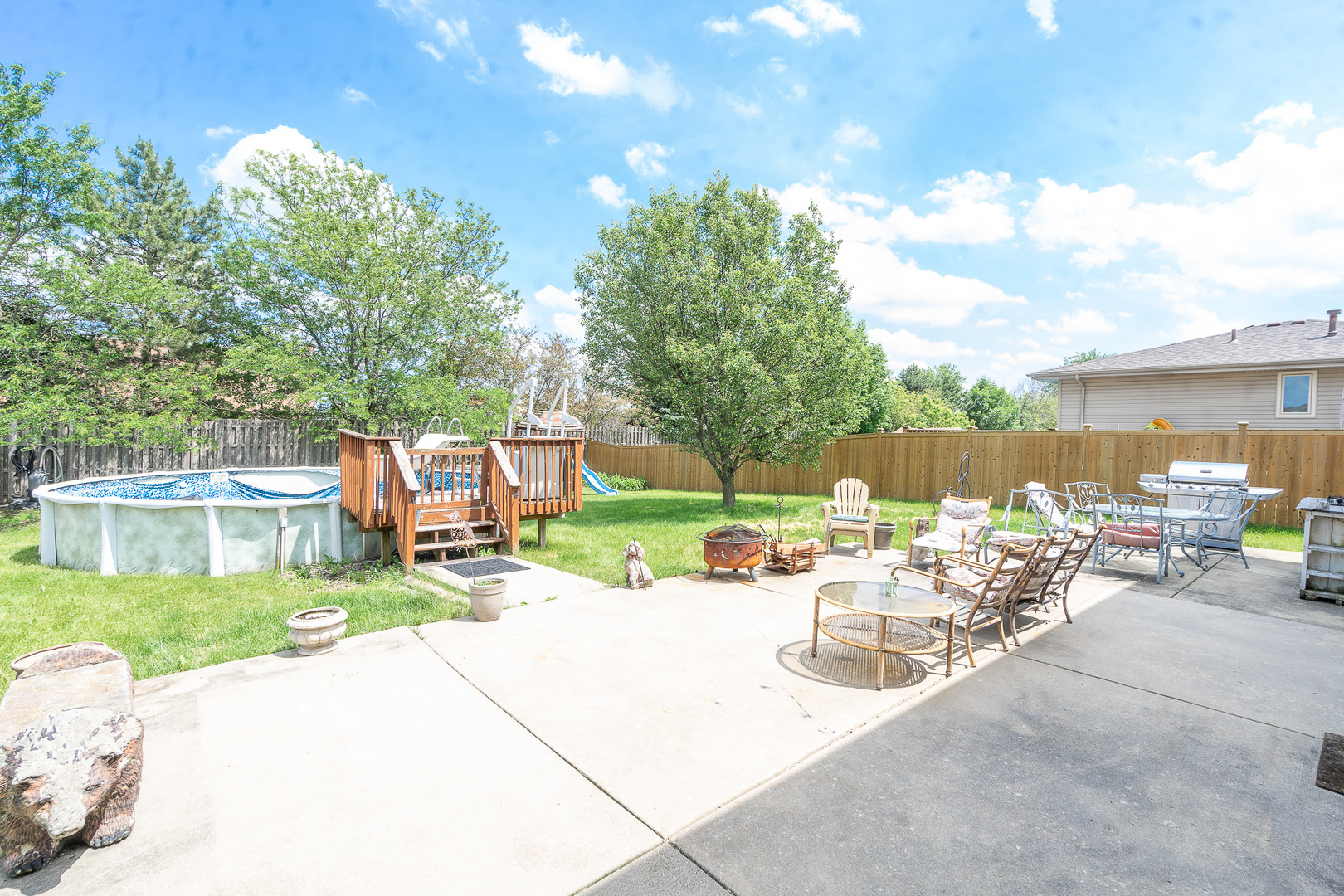 2104 Olde Mill Road Plainfield, IL 60586 - Photo 23 of 23 a view of a patio with table and chairs and a barbeque