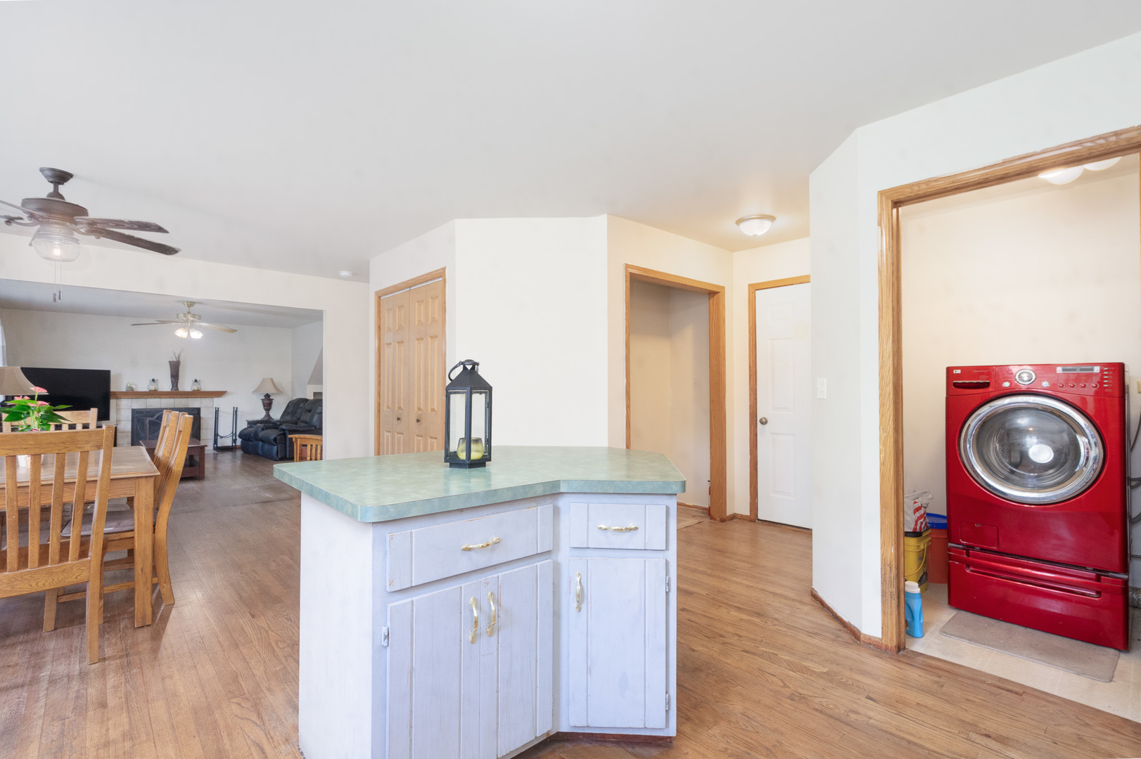 2104 Olde Mill Road Plainfield, IL 60586 - Photo 8 of 23 a kitchen with kitchen island granite countertop a sink a stove a dining table and chairs with wooden floor
