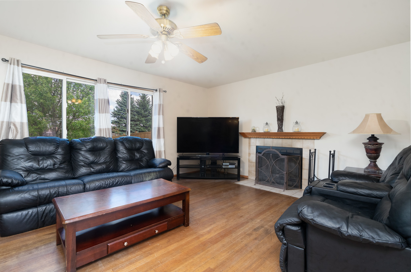 2104 Olde Mill Road Plainfield, IL 60586 - Photo 10 of 23 a living room with furniture a fireplace and a flat screen tv