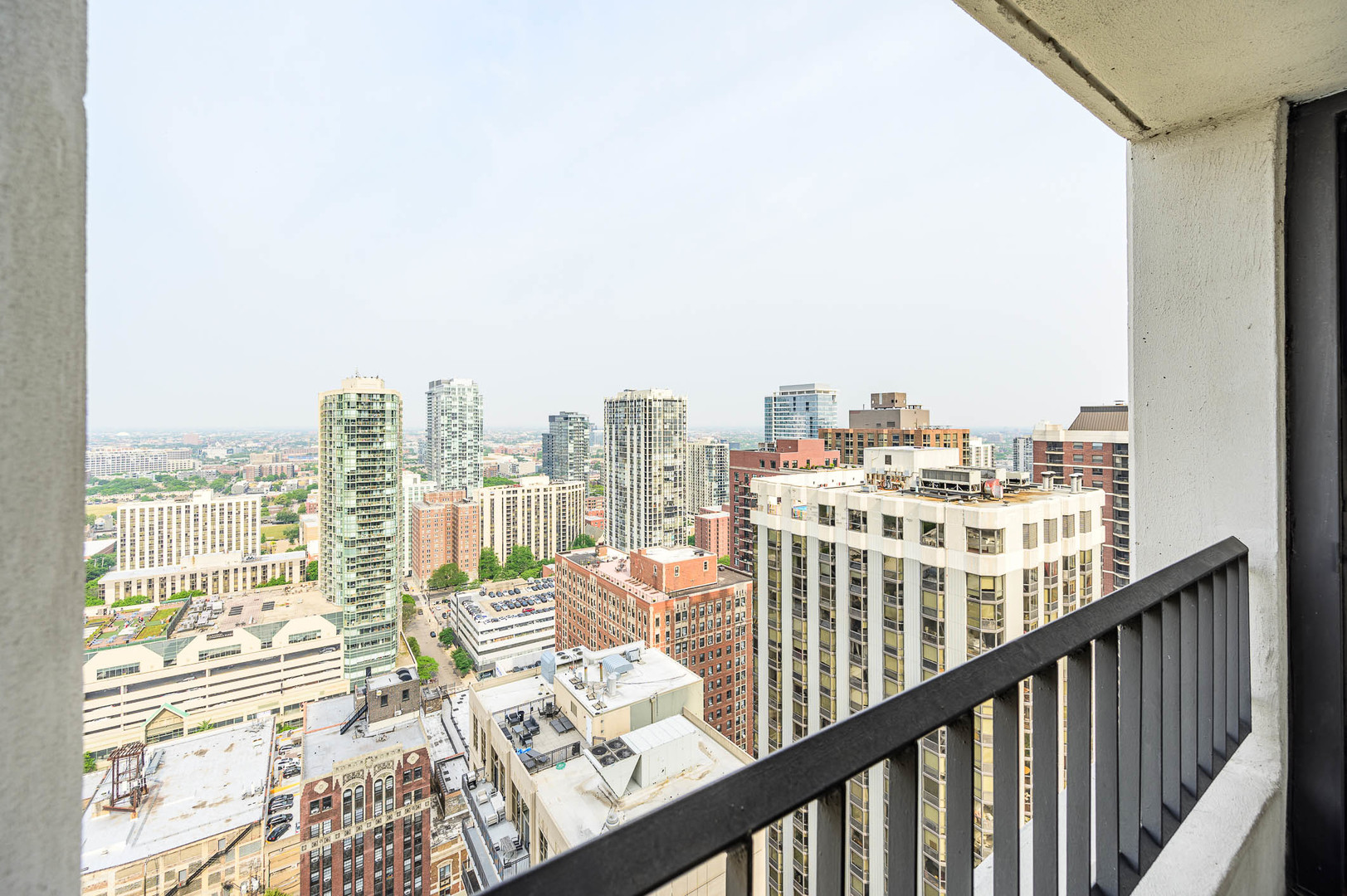 1030 North State Street, Unit 29M Chicago, IL 60610 - Photo 10 of 11 a view of a city from a balcony with city view