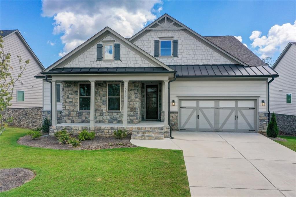 a front view of a house with a garden and plants