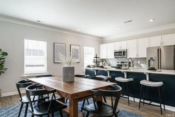 a view of a dining room with furniture and wooden floor