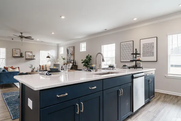 a kitchen with a sink stove and cabinets