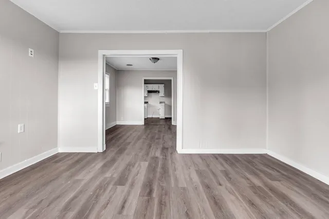 a view of a room with wooden floor and bench