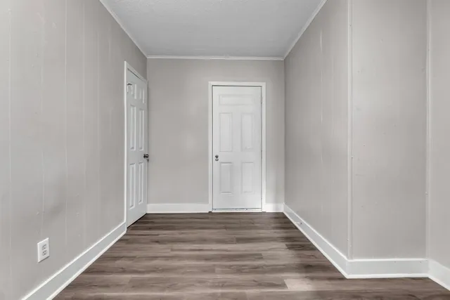 a view of a hallway with wooden floor