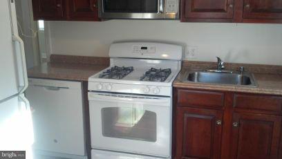 11504 Goodloe Road Silver Spring, MD 20906 - Photo 2 of 7 a stove top oven sitting inside of a kitchen