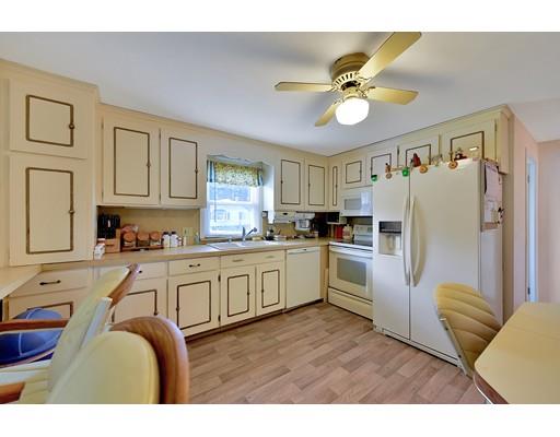 162 Mallowhill Road Springfield, MA 01129 - Photo 10 of 34 a kitchen with granite countertop a refrigerator a sink a stove and white cabinets