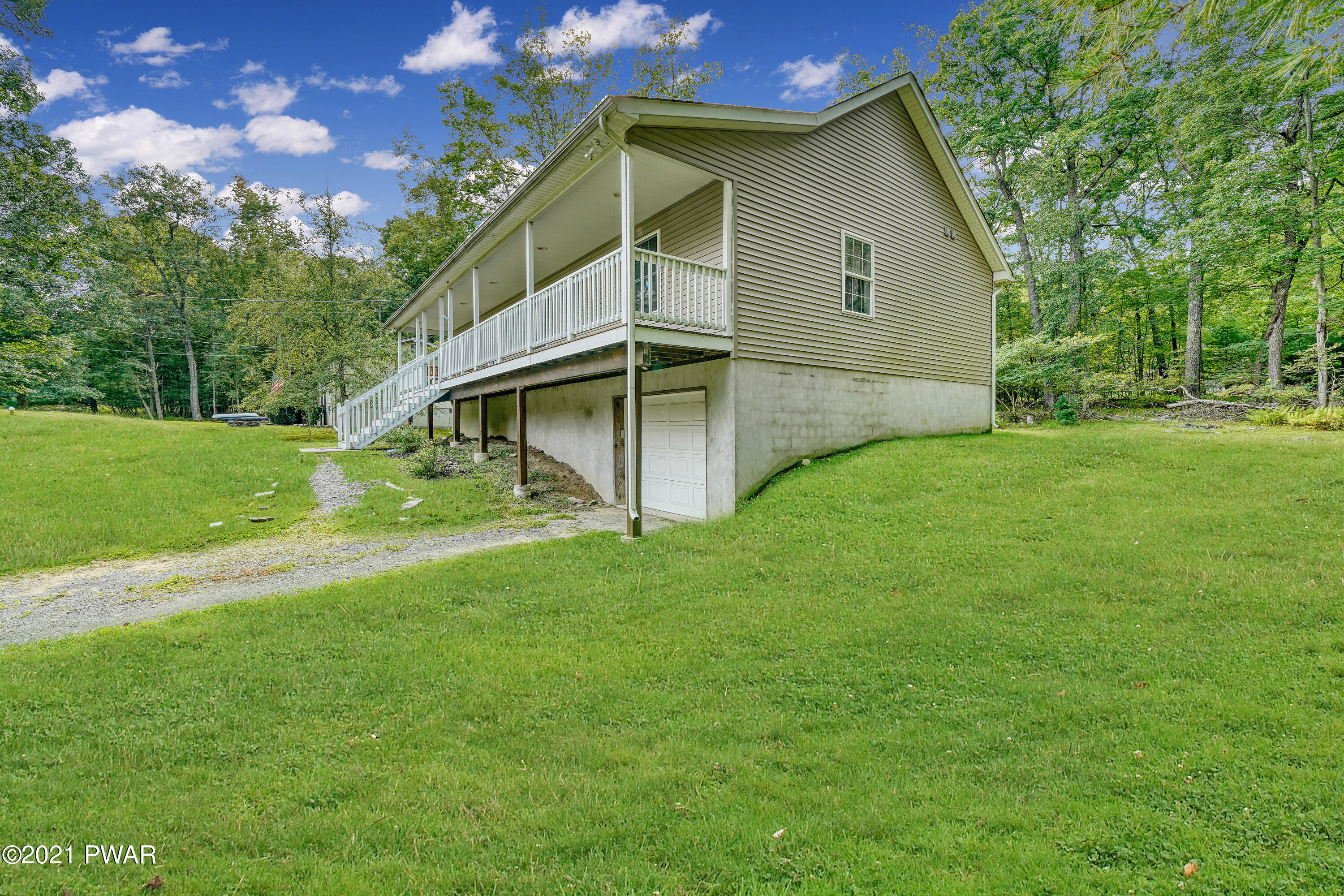 125 Forest Road Dingmans Ferry, PA 18328 - Photo 5 of 28 a house with green field in front of it
