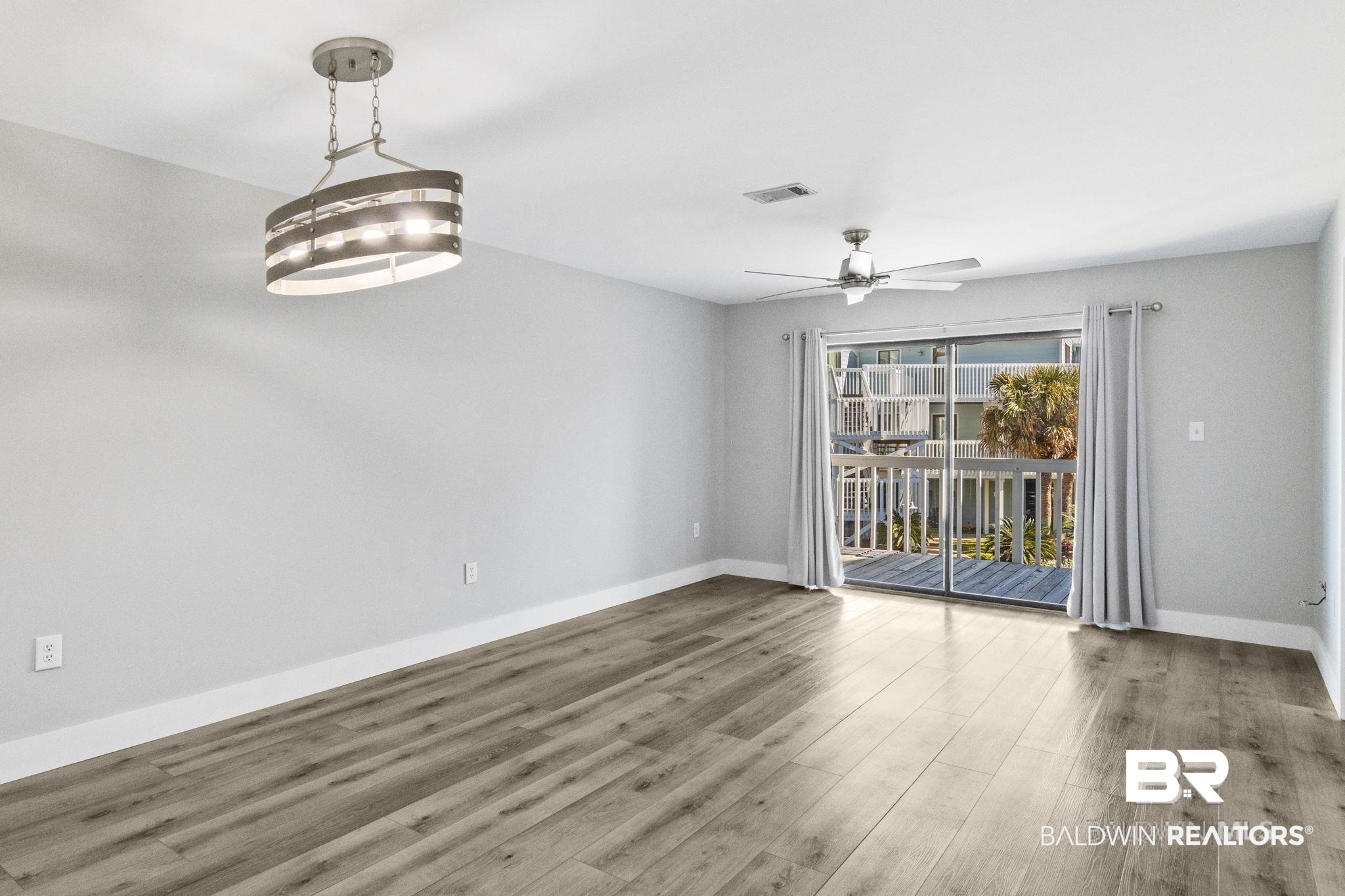 25861 Canal Road, Unit 77 Orange Beach, AL 36561 - Photo 16 of 48 Empty room with baseboards and wood finished floors