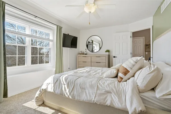 a bedroom with a bed and a window