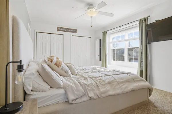 a bed sitting in a bedroom next to a window