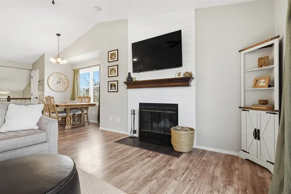a living room with furniture a flat screen tv and a fireplace