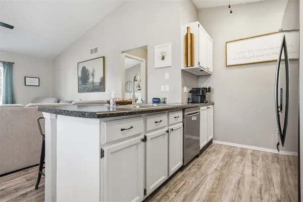 a kitchen with stainless steel appliances granite countertop a refrigerator and a sink