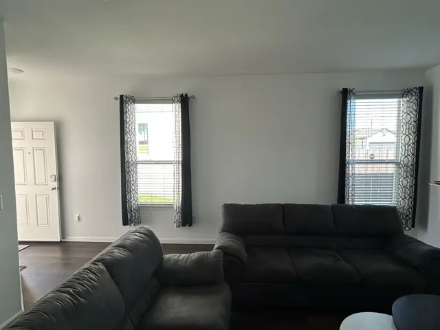 a living room with a couch and a window