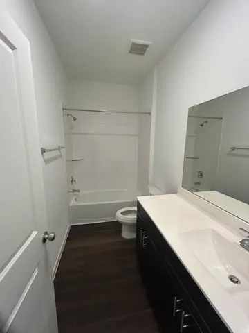 a bathroom with a sink a toilet and vanity