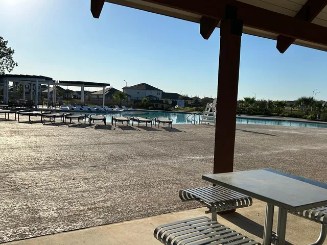 a view of a swimming pool with a yard