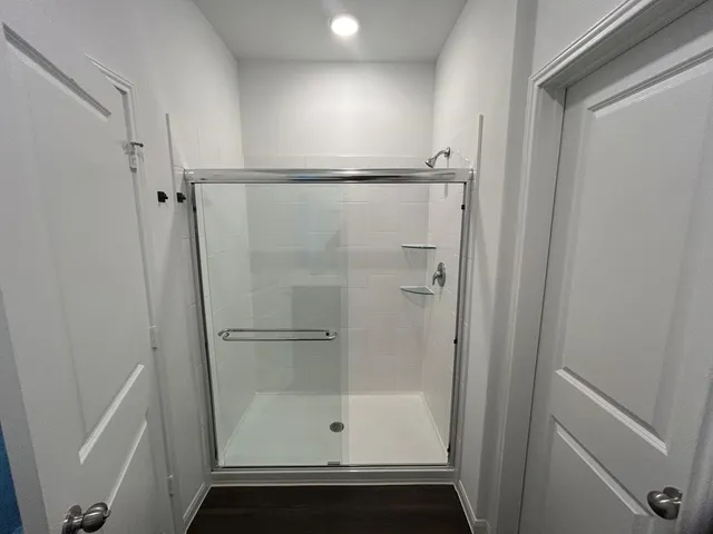 a bathroom with a glass shower door