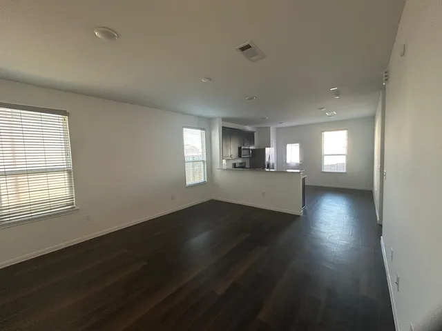 a view of wooden floor and windows in an empty room