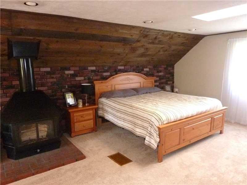 412 Denny Road Valencia, PA 16059 - Photo 12 of 25 Master Bedroom. This area is very spacious and features a coved ceiling with skylights and a wood burning stove to warm you on those chilly nights.