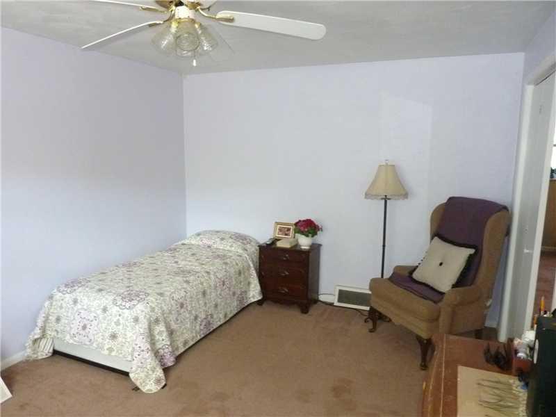 412 Denny Road Valencia, PA 16059 - Photo 15 of 25 Bedroom. Two other bedrooms are situated on the lower level. This one offers a ceiling fan and neutral carpeting.