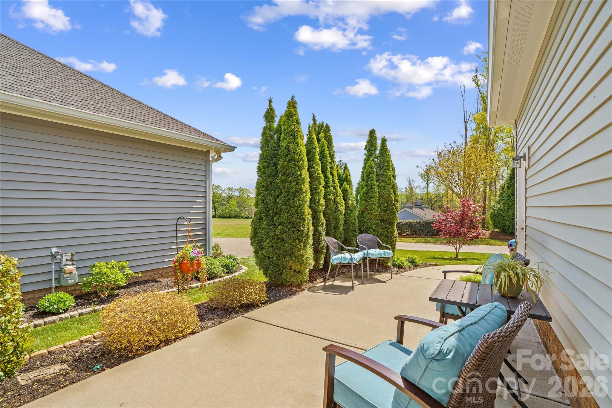 11528 Dublin Cres Road Cornelius, NC 28031 - Photo 29 of 35 a view of a patio with chairs and table with potted plants