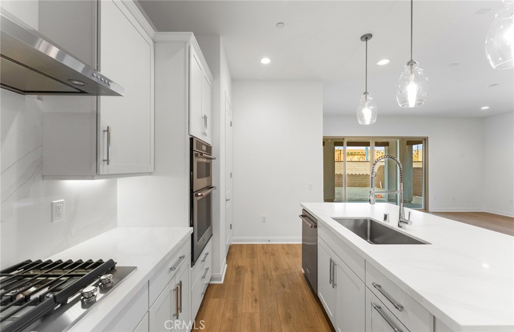 743 Corkscrew Road Rancho Mission Viejo, CA 92694 - Photo 11 of 35 a kitchen with a sink stove and cabinets