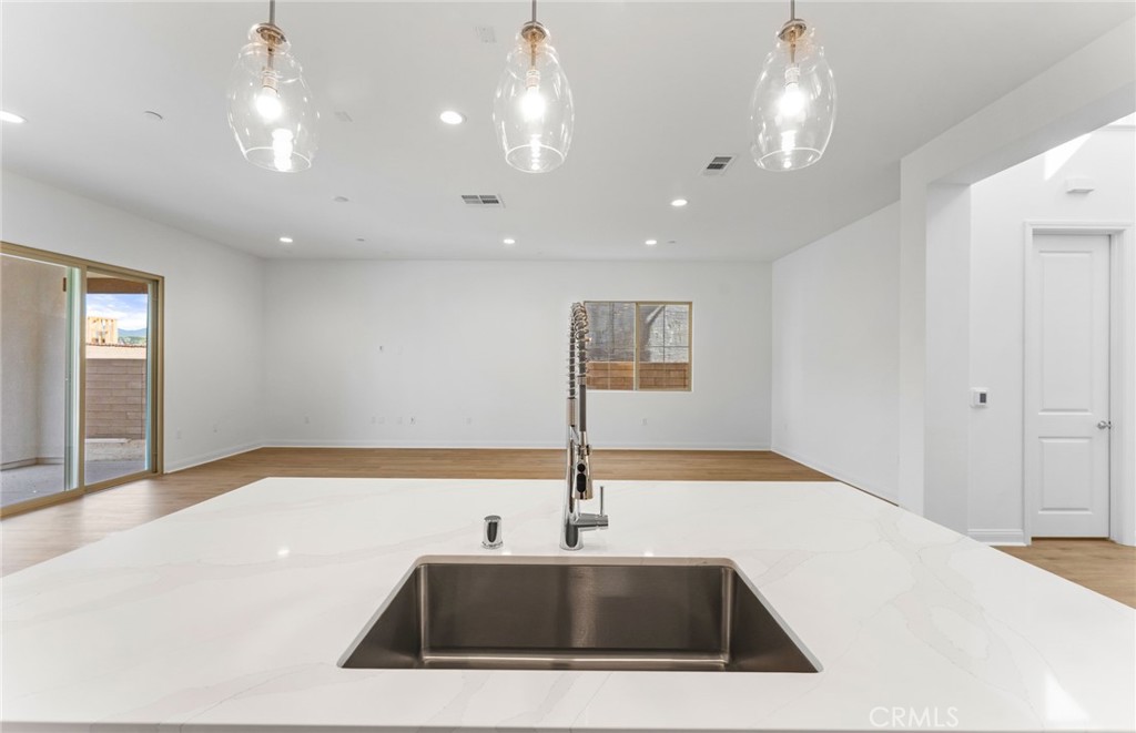 743 Corkscrew Road Rancho Mission Viejo, CA 92694 - Photo 12 of 35 a kitchen with a sink a center island and stainless steel appliances