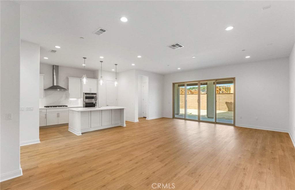 743 Corkscrew Road Rancho Mission Viejo, CA 92694 - Photo 3 of 35 a view of kitchen with wooden floor and electronic appliances