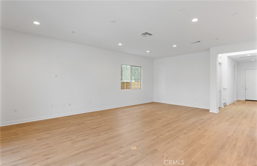 743 Corkscrew Road Rancho Mission Viejo, CA 92694 - Photo 5 of 35 a view of an empty room with wooden floor and a window