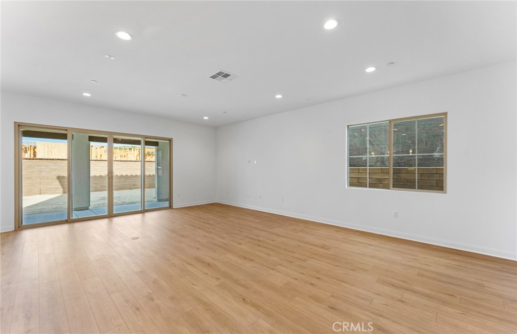 743 Corkscrew Road Rancho Mission Viejo, CA 92694 - Photo 6 of 35 an empty room with wooden floor and windows