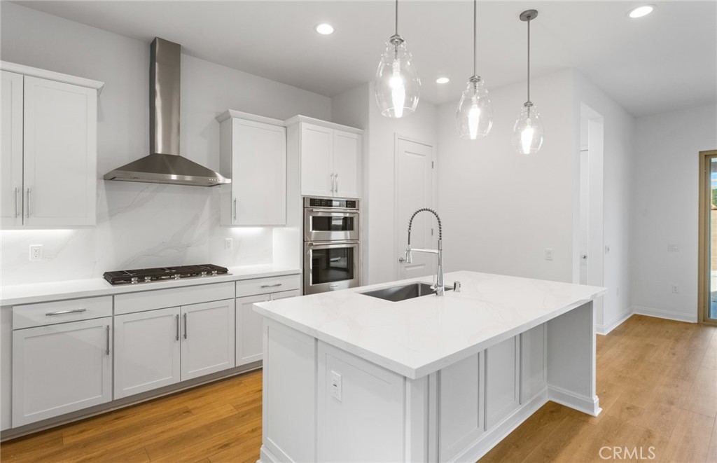 743 Corkscrew Road Rancho Mission Viejo, CA 92694 - Photo 9 of 35 a kitchen with a sink a stove and cabinets