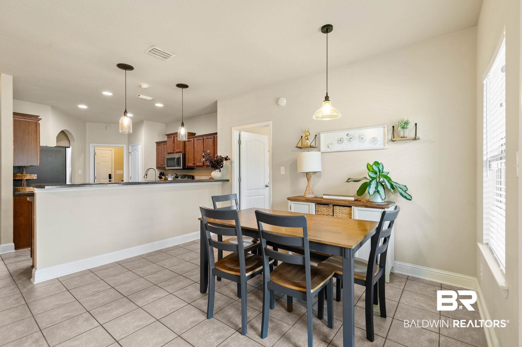 2216 Livingstone Court Mobile, AL 36695 - Photo 10 of 62 Dining area featuring ceramic tile flooring, a window with blinds, and a suspended light fixture