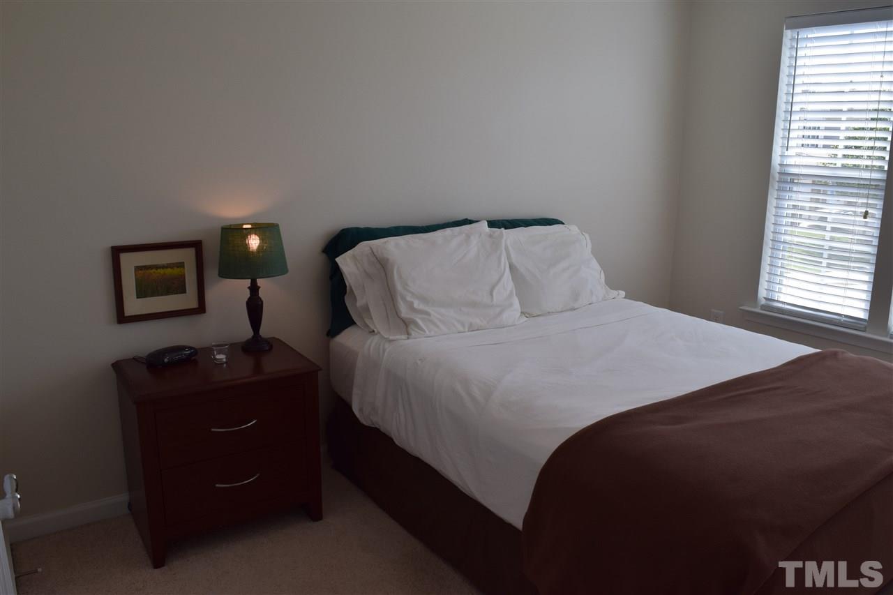 8702 Redcrest Place Raleigh, NC 27617 - Photo 9 of 22 a bedroom with a bed and a window