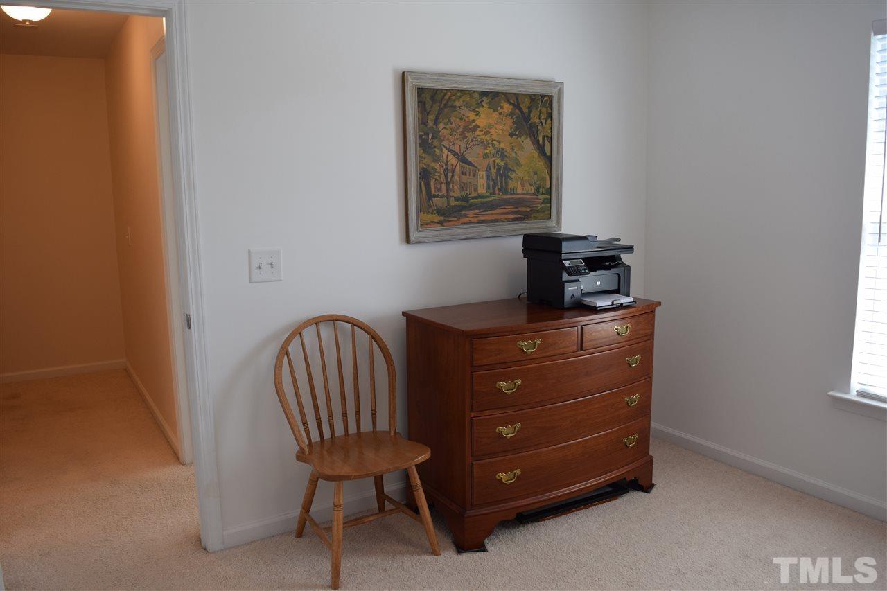 8702 Redcrest Place Raleigh, NC 27617 - Photo 11 of 22 a room with a dresser and a chair