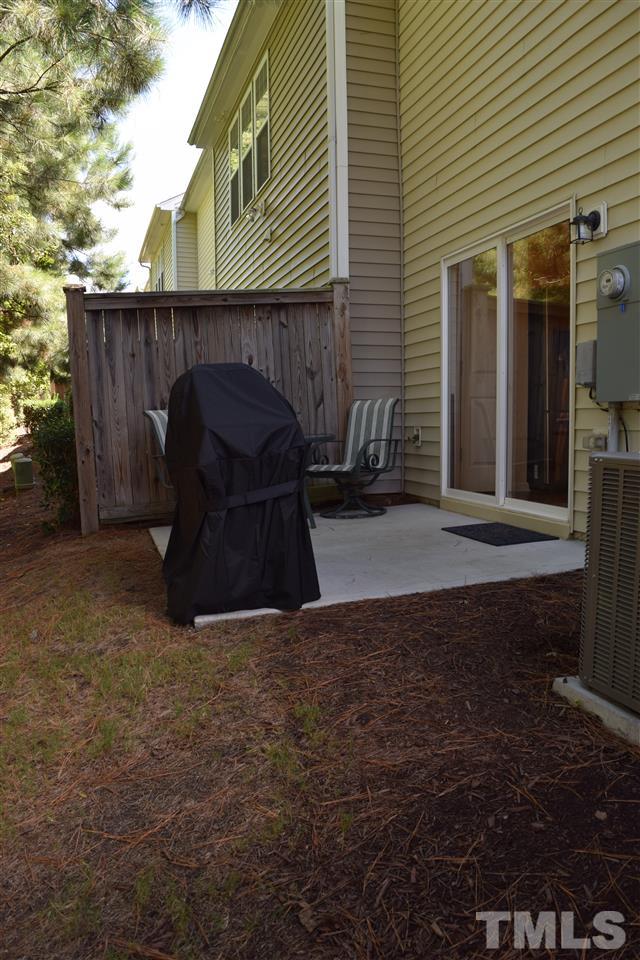 8702 Redcrest Place Raleigh, NC 27617 - Photo 15 of 22 a backyard of a house with barbeque oven and outdoor seating