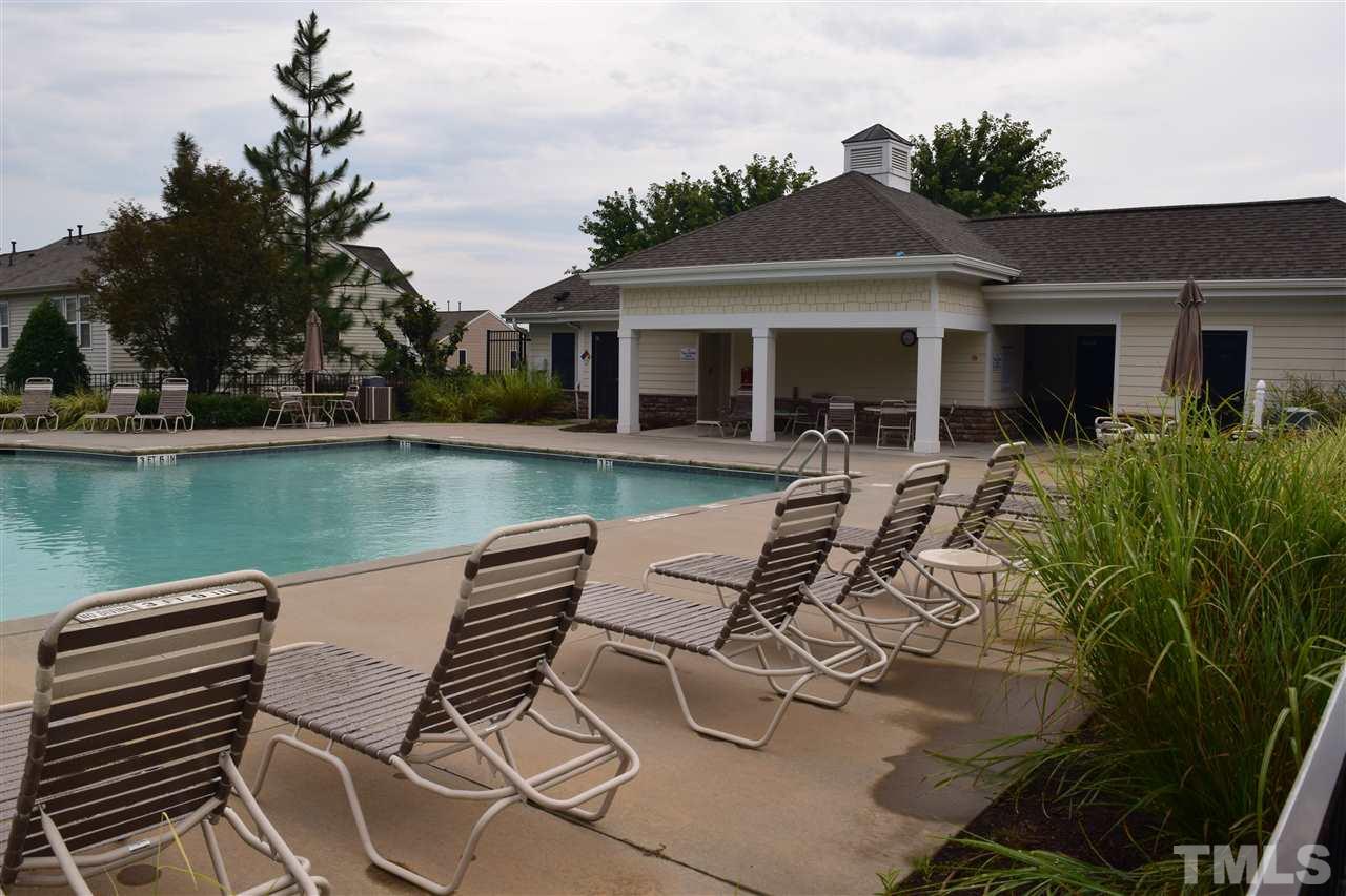 8702 Redcrest Place Raleigh, NC 27617 - Photo 18 of 22 a view of a patio with table and chairs potted plants and large tree