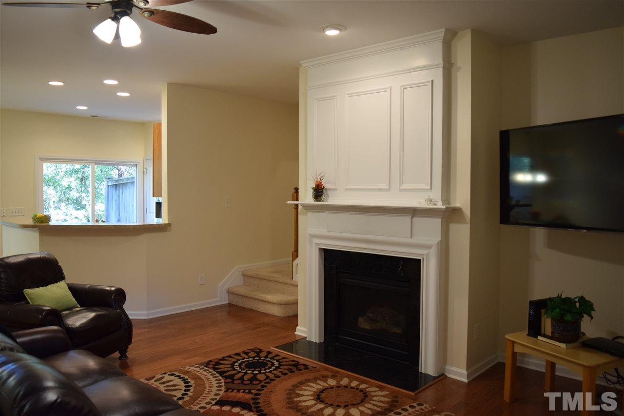 8702 Redcrest Place Raleigh, NC 27617 - Photo 21 of 22 a living room with furniture and a fireplace