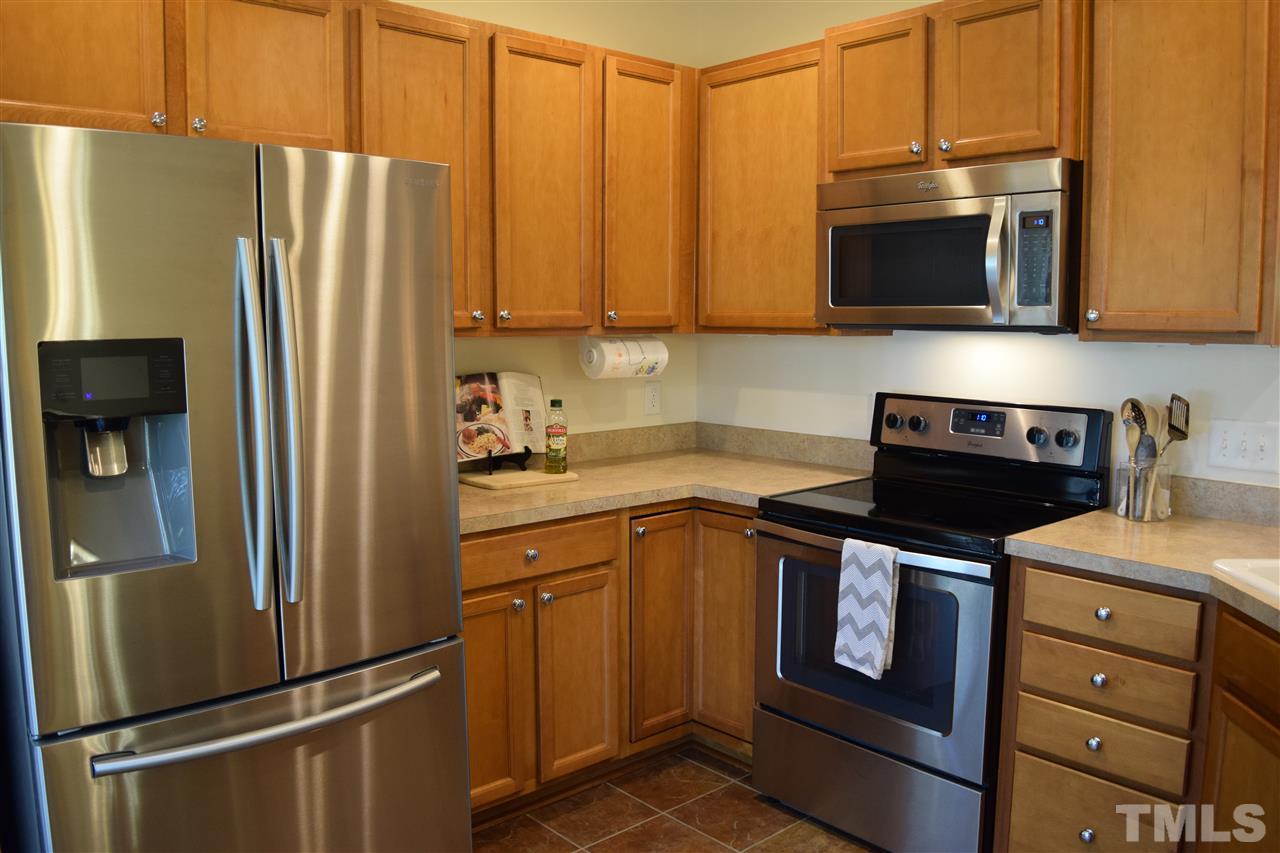 8702 Redcrest Place Raleigh, NC 27617 - Photo 4 of 22 a kitchen with stainless steel appliances granite countertop a refrigerator stove and microwave