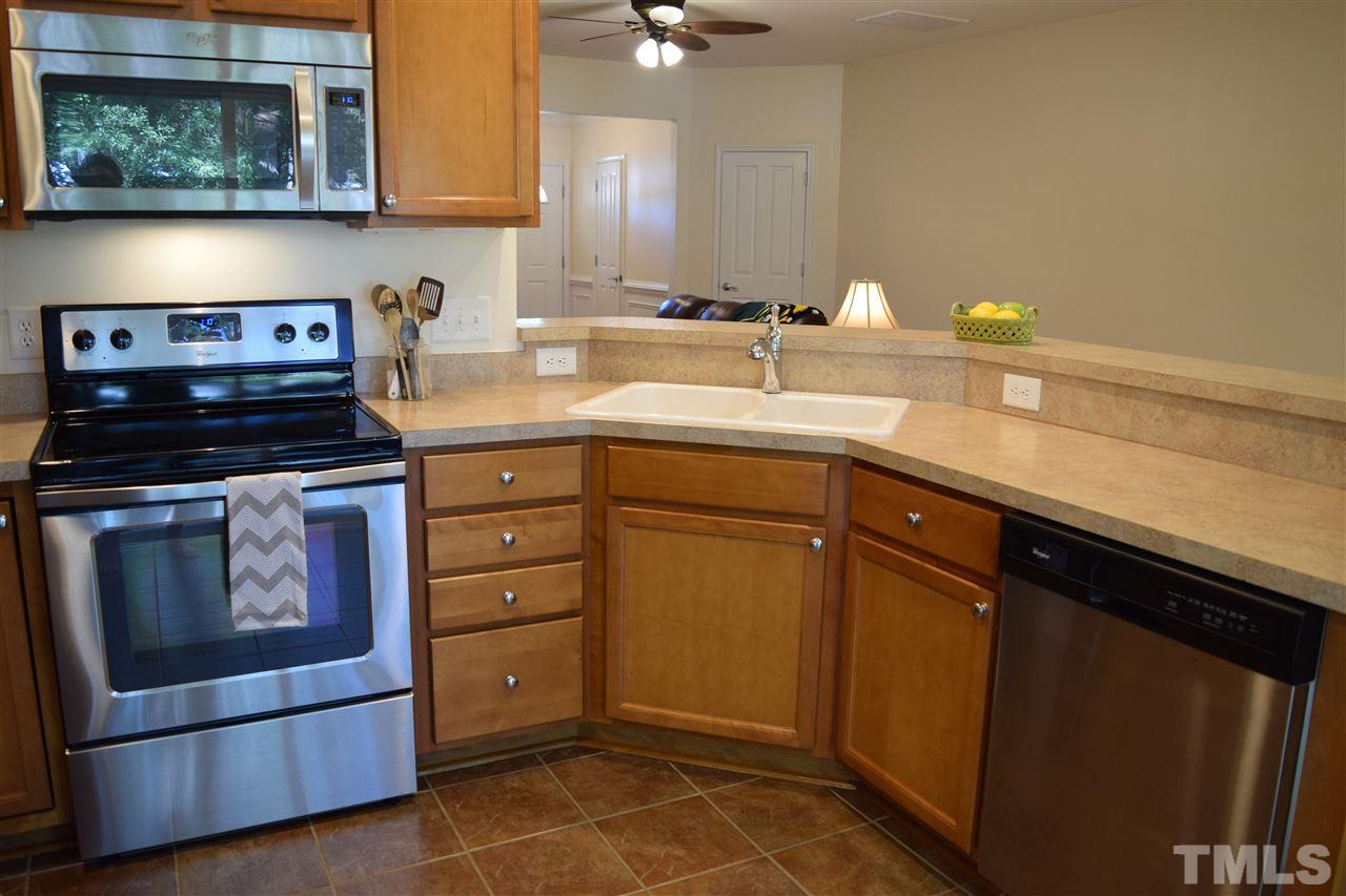 8702 Redcrest Place Raleigh, NC 27617 - Photo 5 of 22 a kitchen with appliances cabinets and a sink