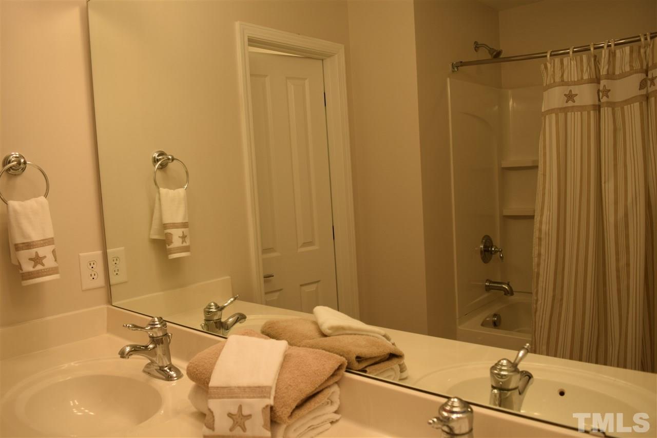 8702 Redcrest Place Raleigh, NC 27617 - Photo 7 of 22 a bathroom with a sink and a mirror