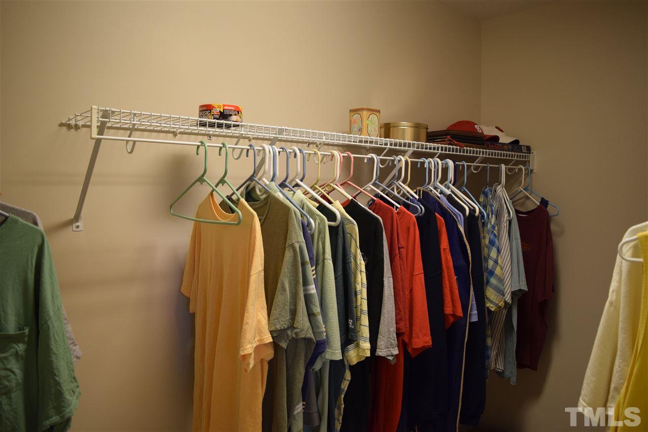 8702 Redcrest Place Raleigh, NC 27617 - Photo 8 of 22 a view of walk in closet with clothes and shoes