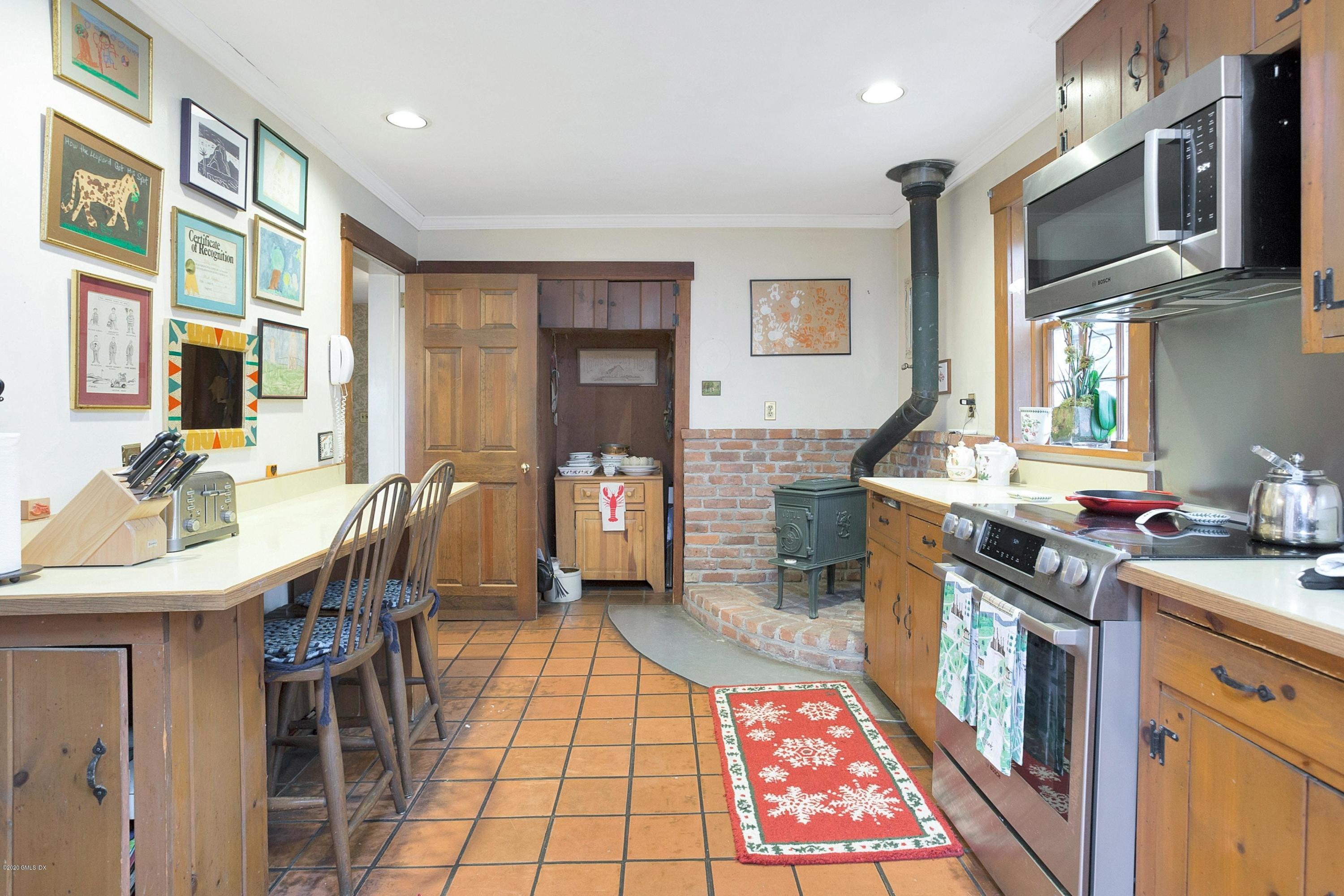 207 Round Hill Road Greenwich, CT 06831 - Photo 11 of 28 a kitchen with stainless steel appliances granite countertop a stove a sink dishwasher a microwave oven with granite countertops and cabinets