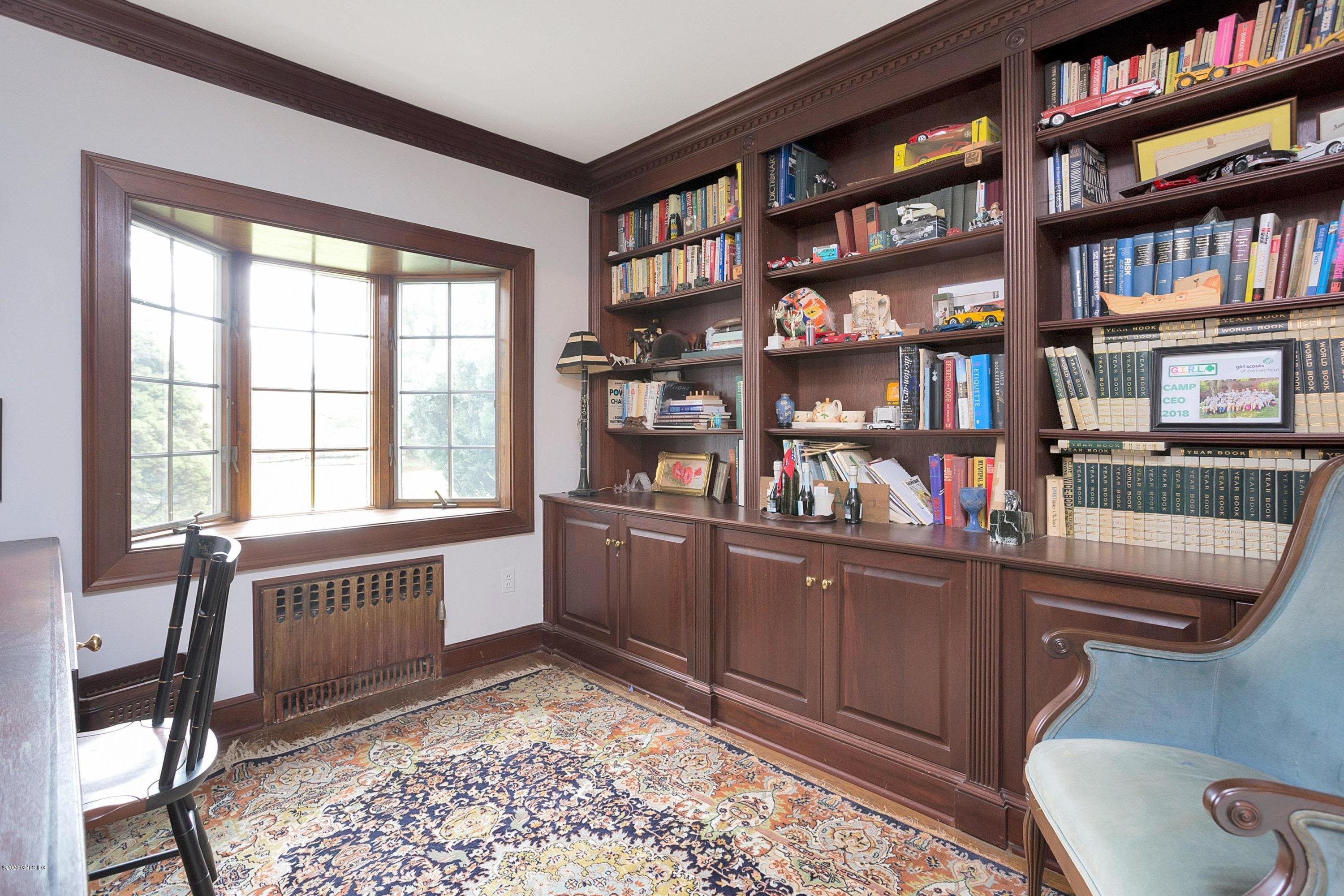 207 Round Hill Road Greenwich, CT 06831 - Photo 13 of 28 a room with furniture and a book shelf