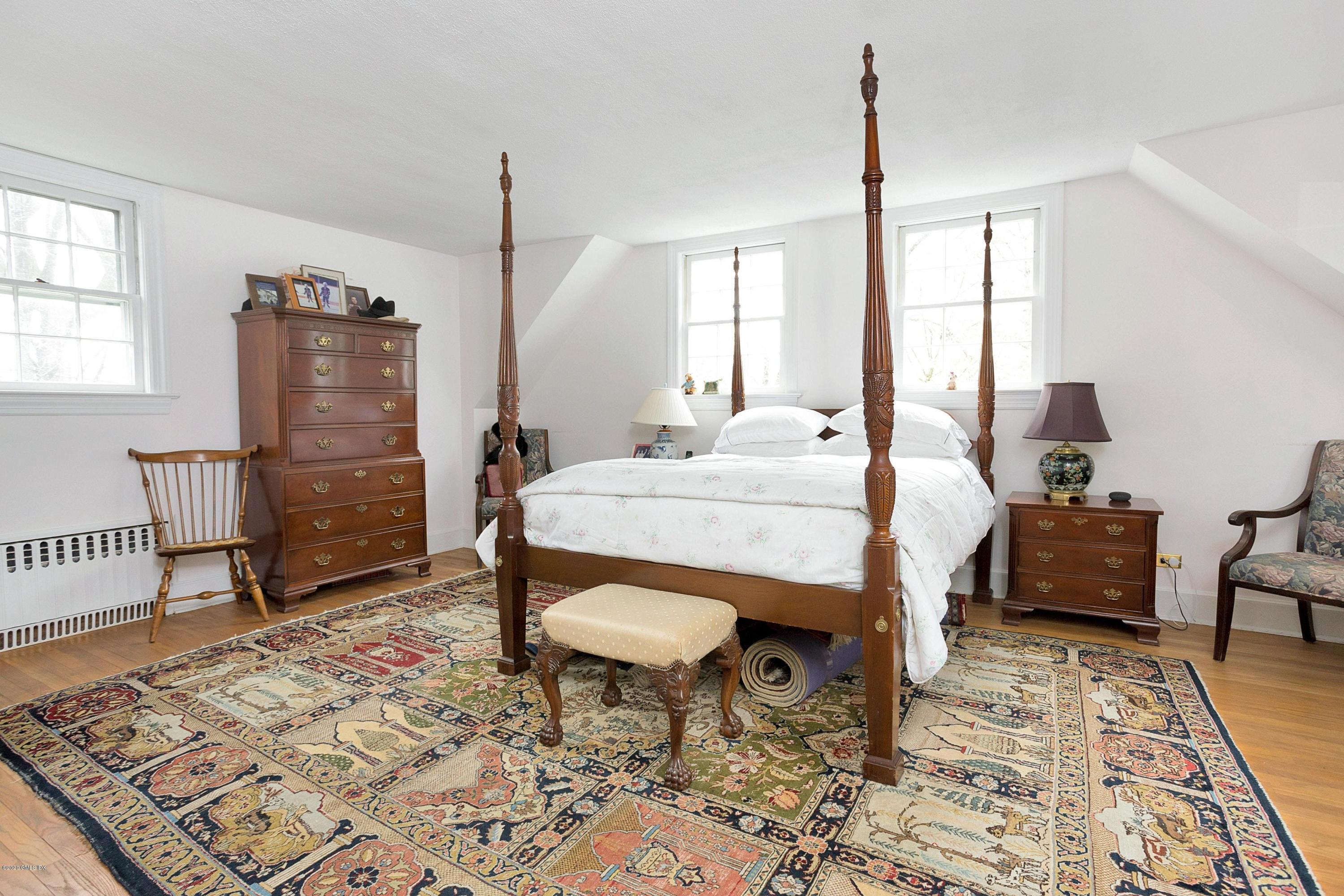 207 Round Hill Road Greenwich, CT 06831 - Photo 14 of 28 a bed room with a bed and a table