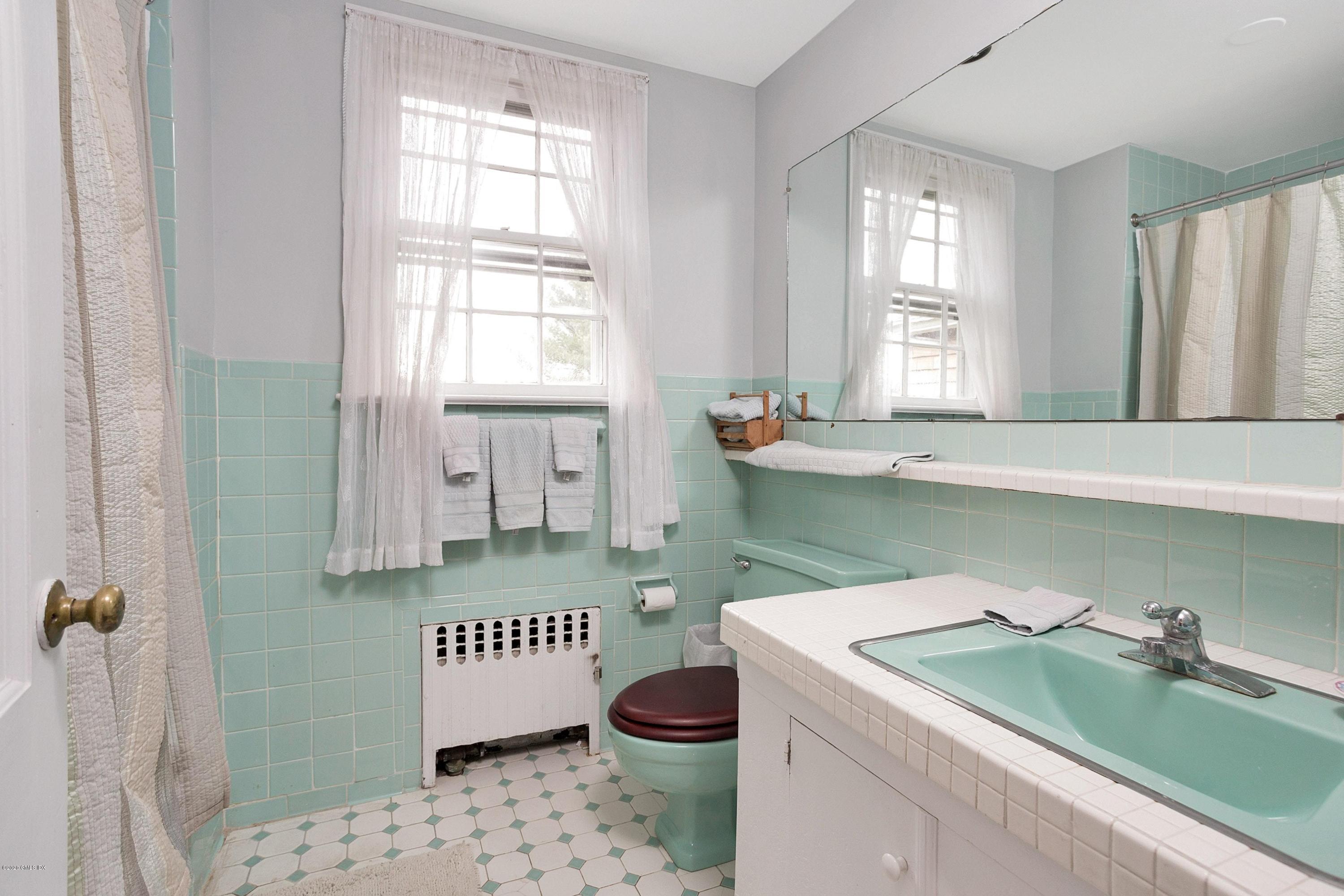 207 Round Hill Road Greenwich, CT 06831 - Photo 15 of 28 a bathroom with a sink toilet and window