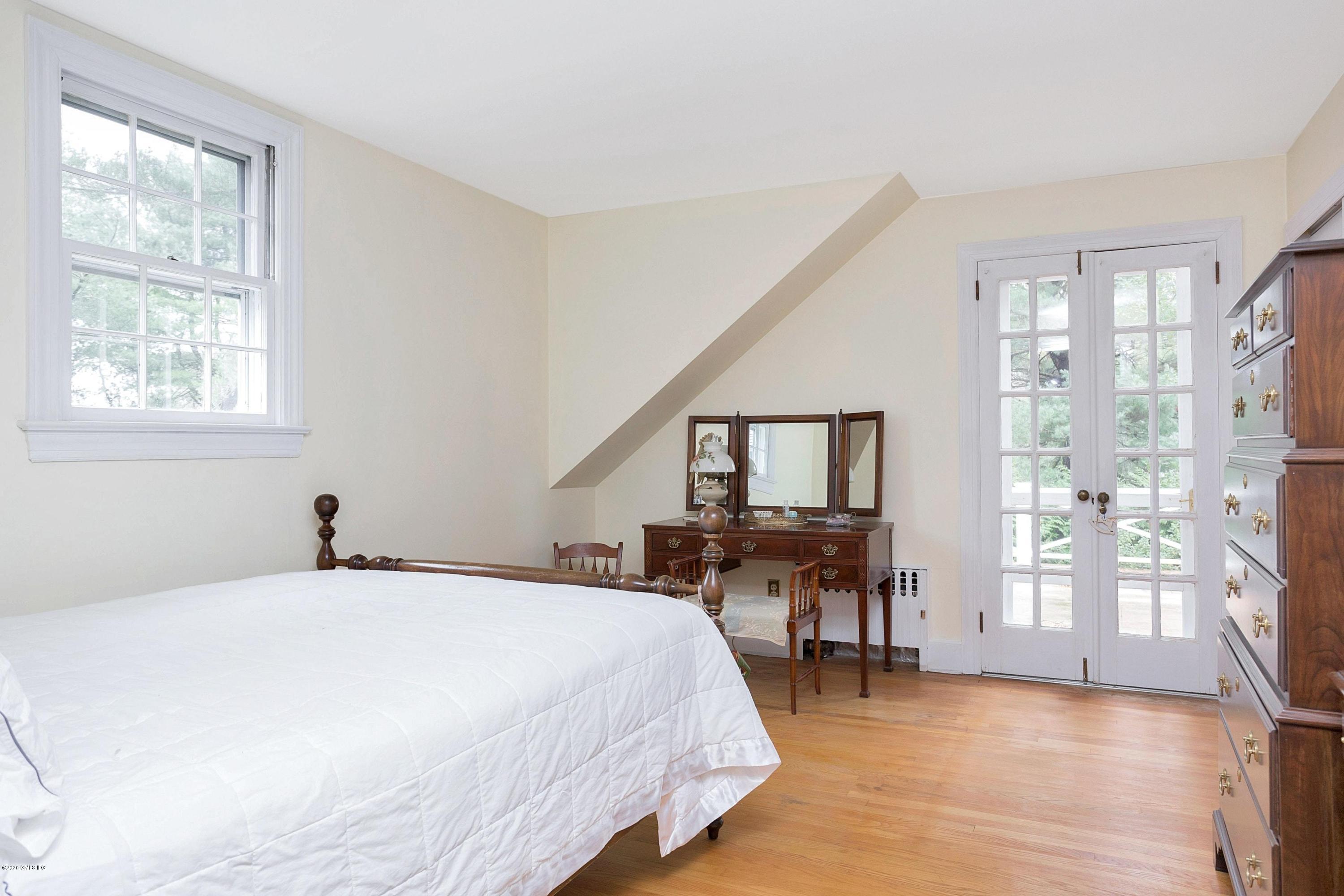 207 Round Hill Road Greenwich, CT 06831 - Photo 16 of 28 a bedroom with a bed and wooden floor