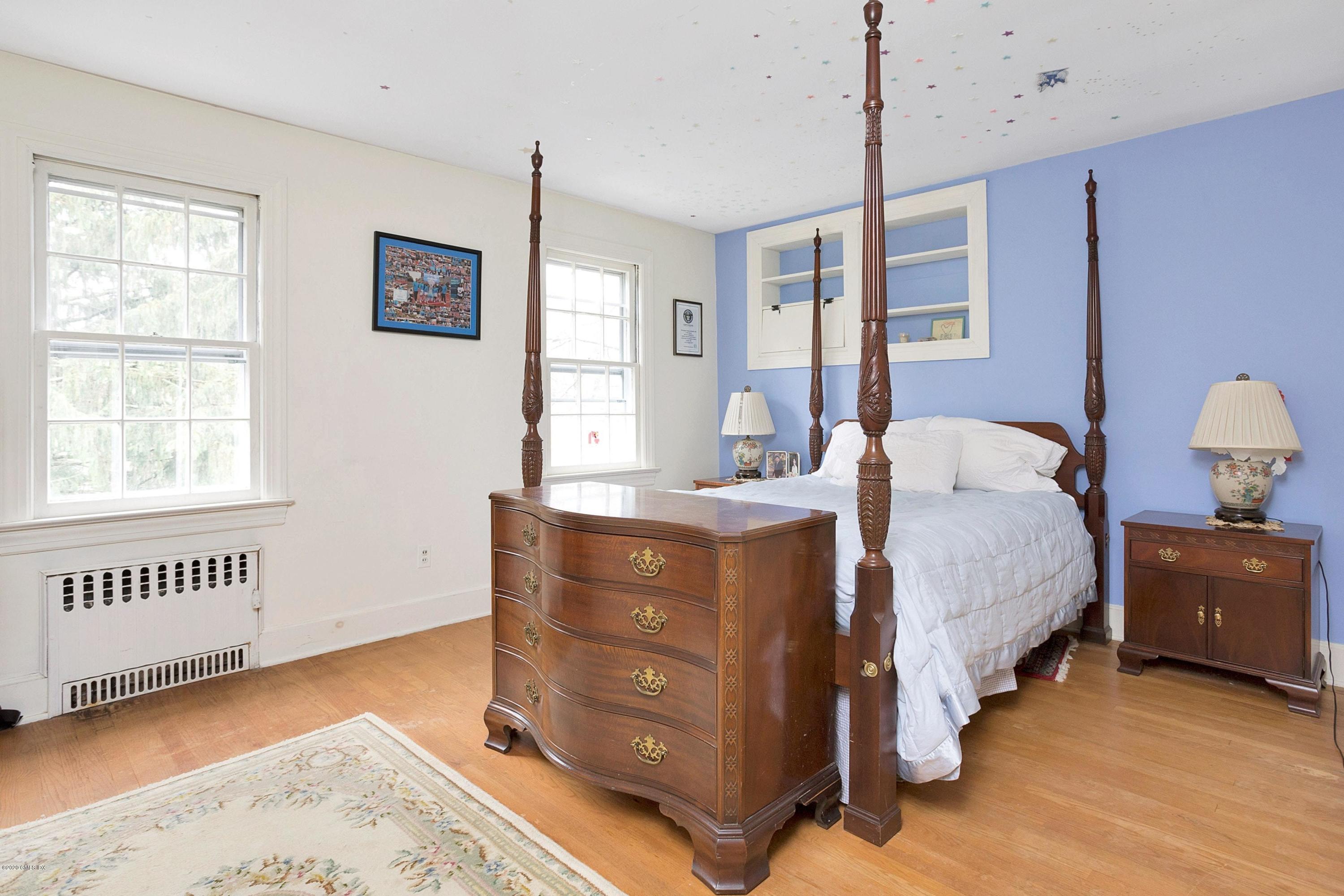 207 Round Hill Road Greenwich, CT 06831 - Photo 18 of 28 a bed room with a bed and a window