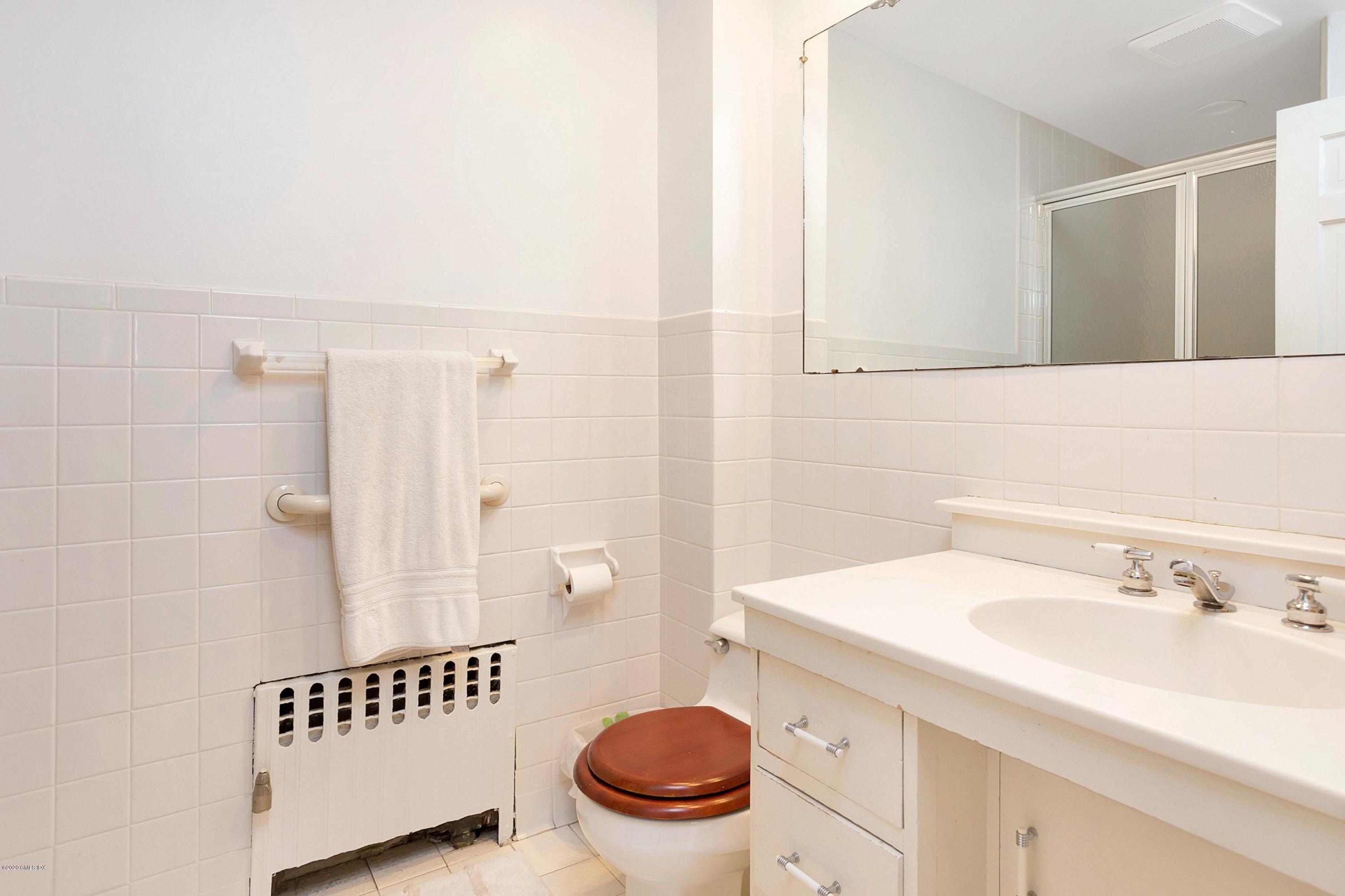 207 Round Hill Road Greenwich, CT 06831 - Photo 19 of 28 a bathroom with a sink a toilet and a mirror