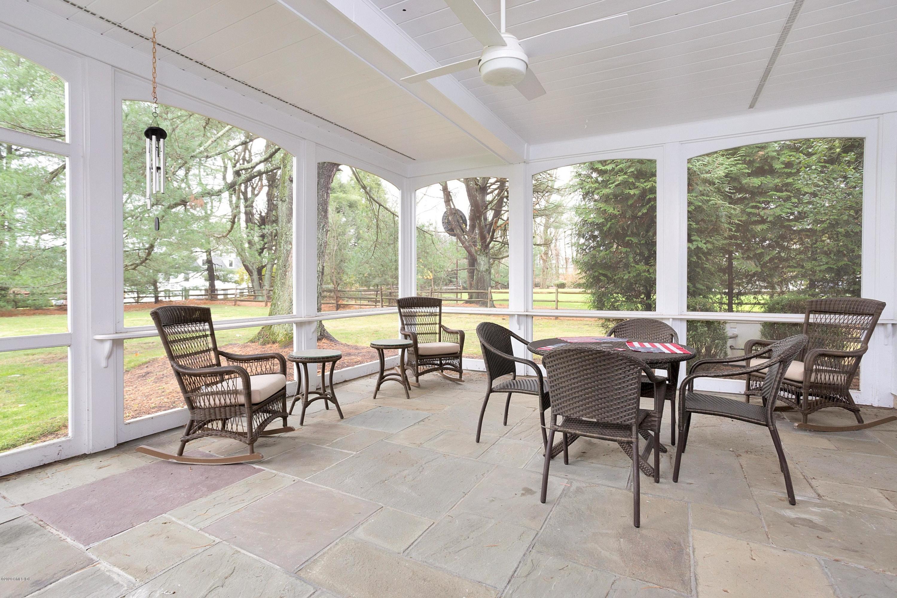 207 Round Hill Road Greenwich, CT 06831 - Photo 20 of 28 a view of a dining room with furniture large windows and wooden floor